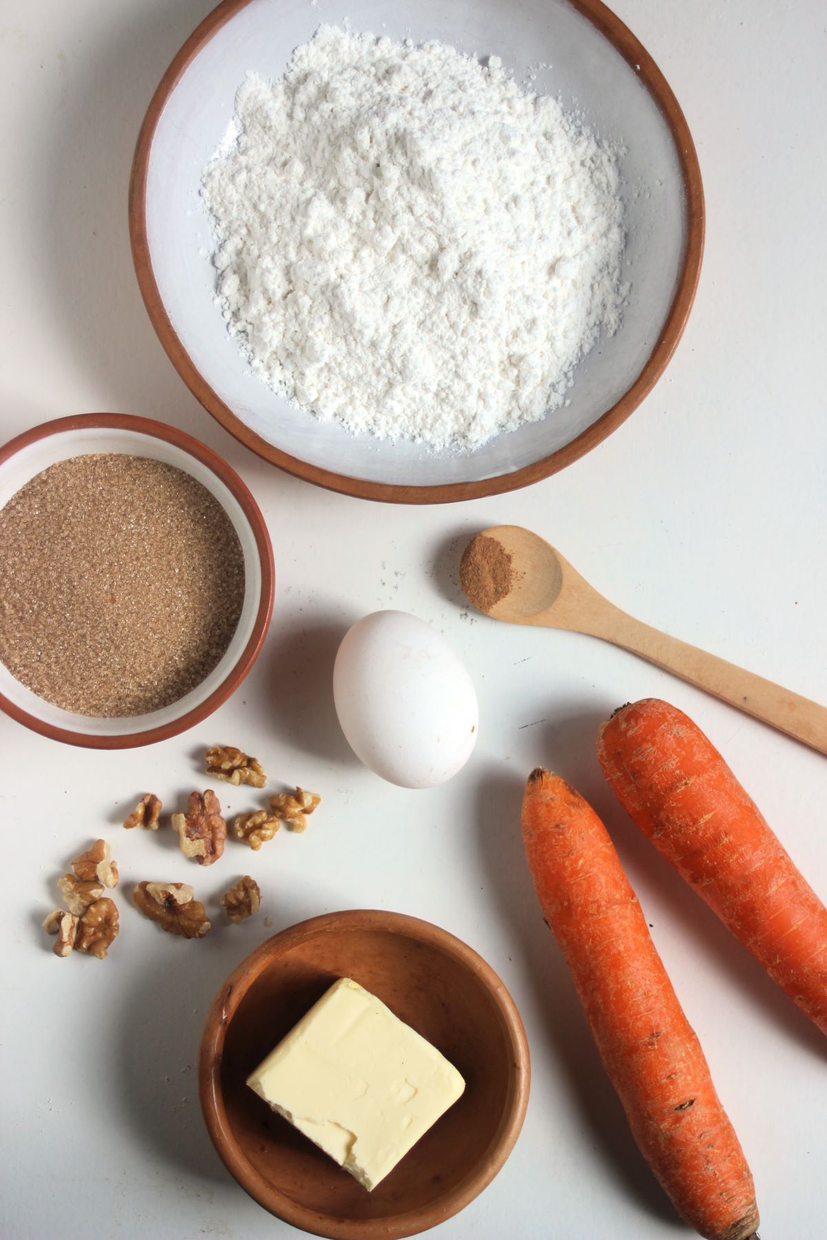 Gluten-free carrot cake cookies ingredients on a white surface seen from above.