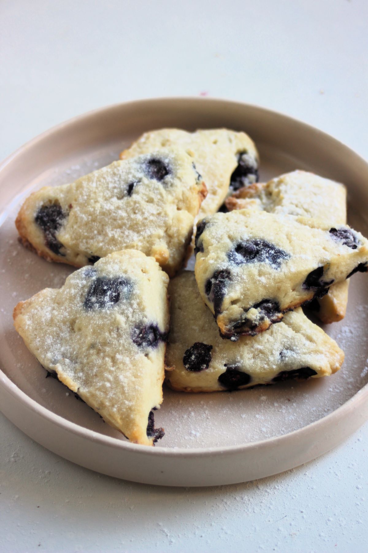 Blueberry scones on a cream colour plate.