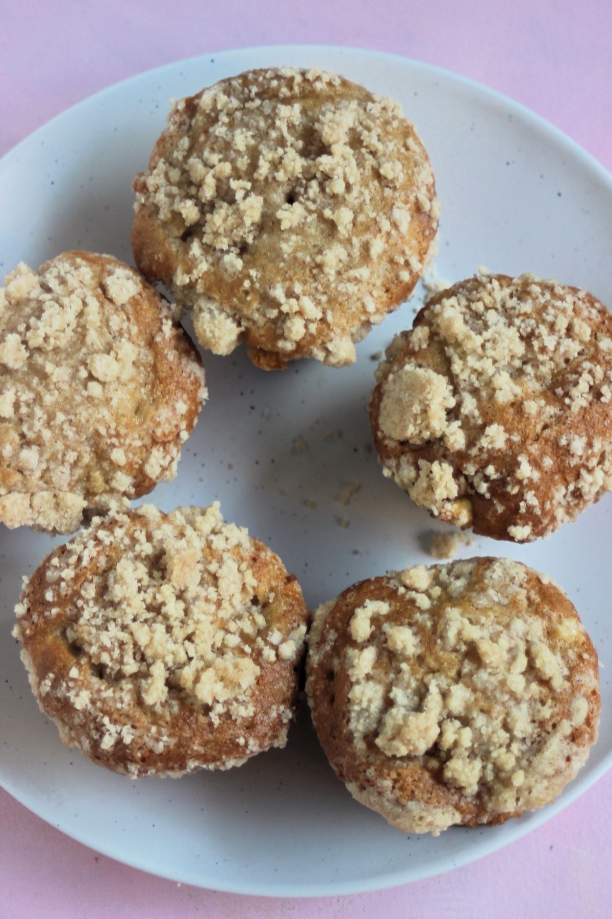 Apple crumb muffins on a white plate. seen from above.