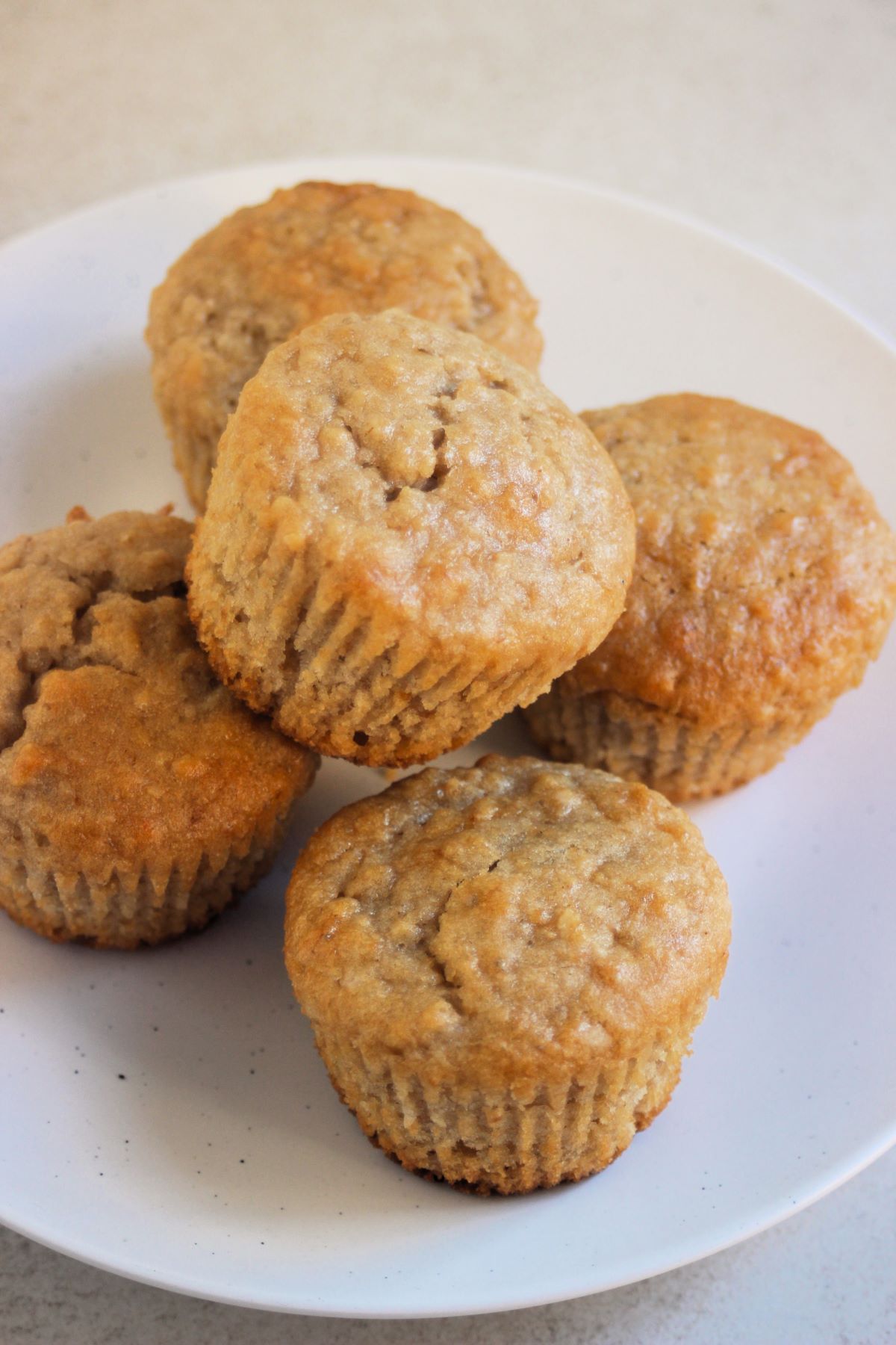 Oatmeal muffins on a white plate.