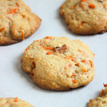 Carrot cake cookies on a white surface.