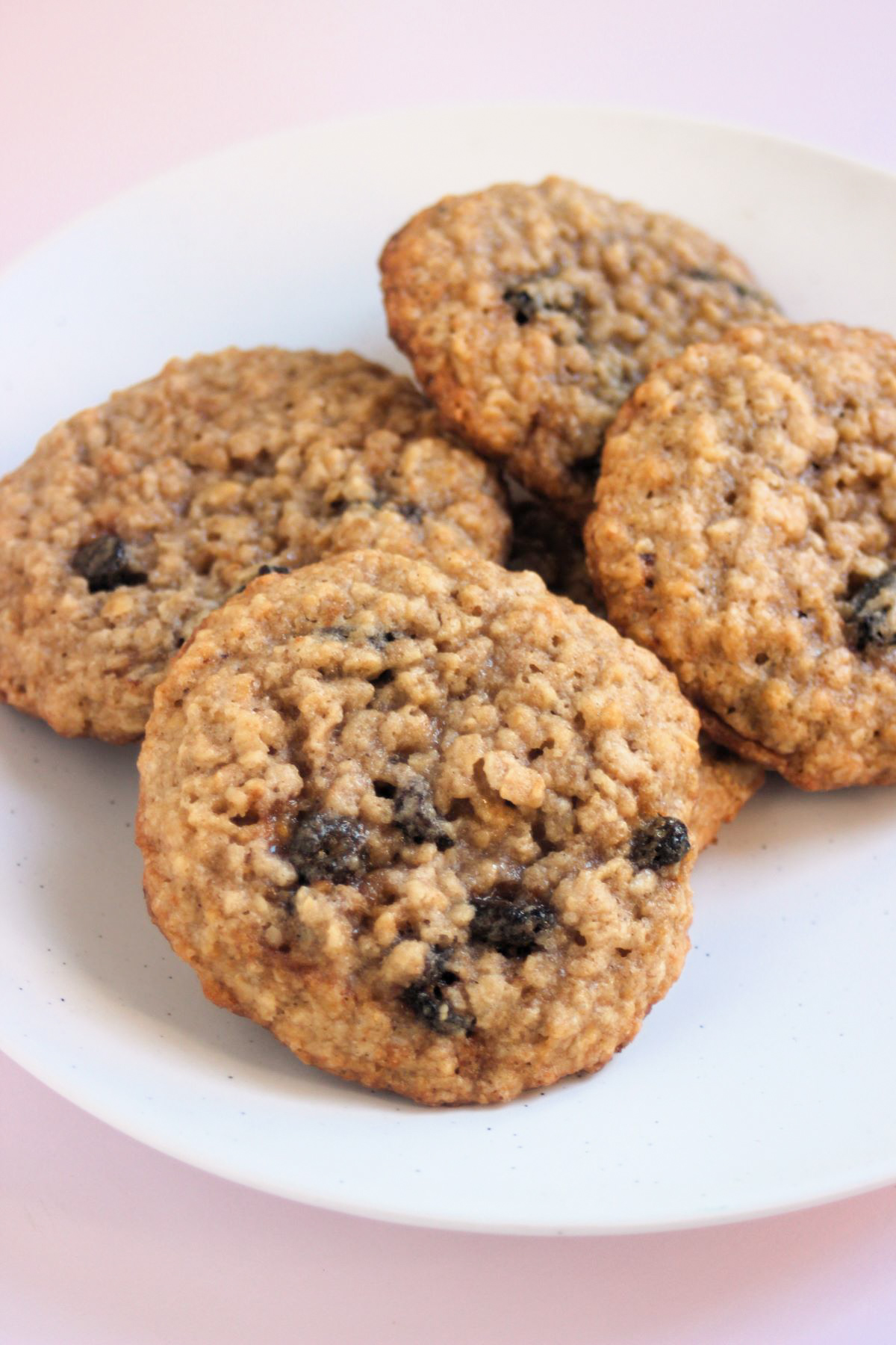 Oatmeal raisin cookies on a white plate.