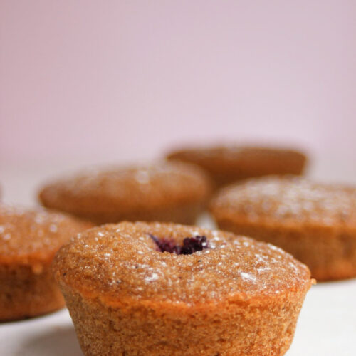 A financier on a white surface. Many financiers are in the background.