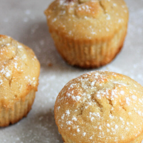 Pear and ginger muffins on a white surface.