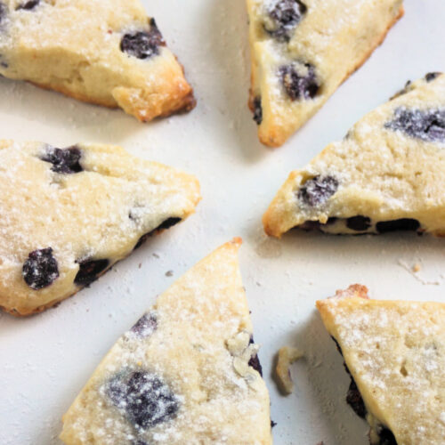 Blueberry scones on a white surface.