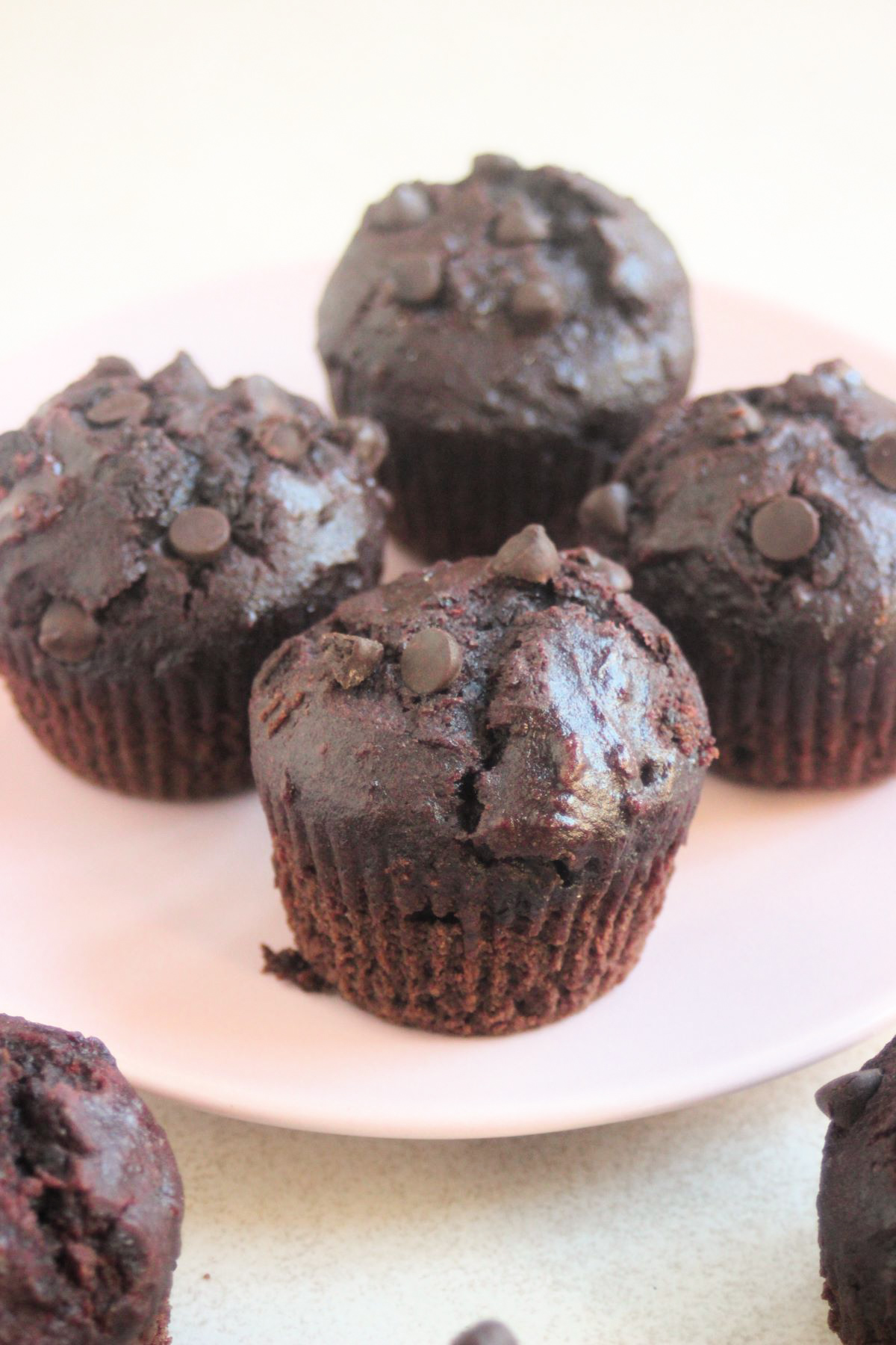 Chocolate beet muffins on a pink plate.