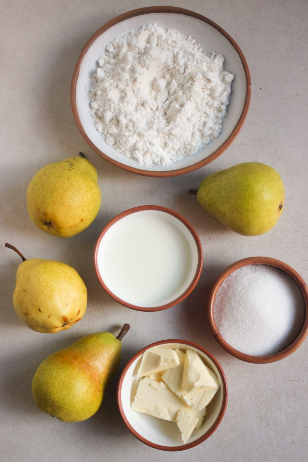 Pear Cobbler ingredients on a white surface seen from above.