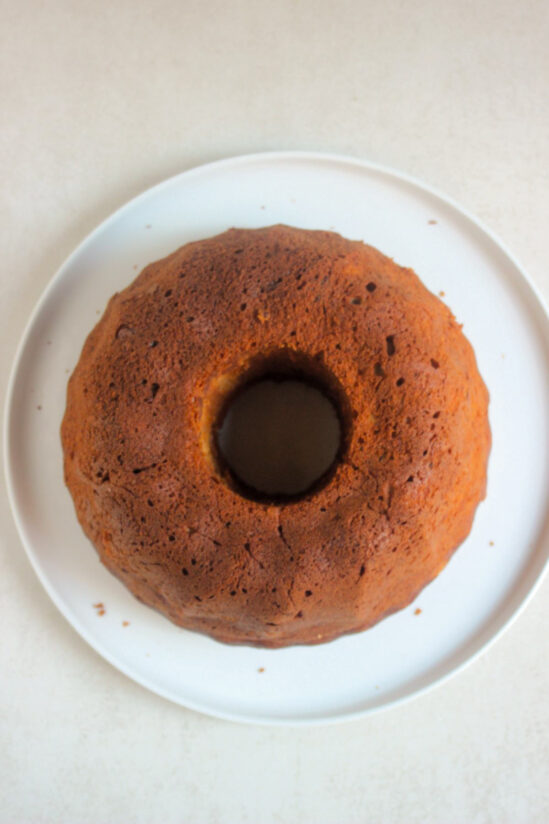 Banana bundt cake on a white plate seen from above.