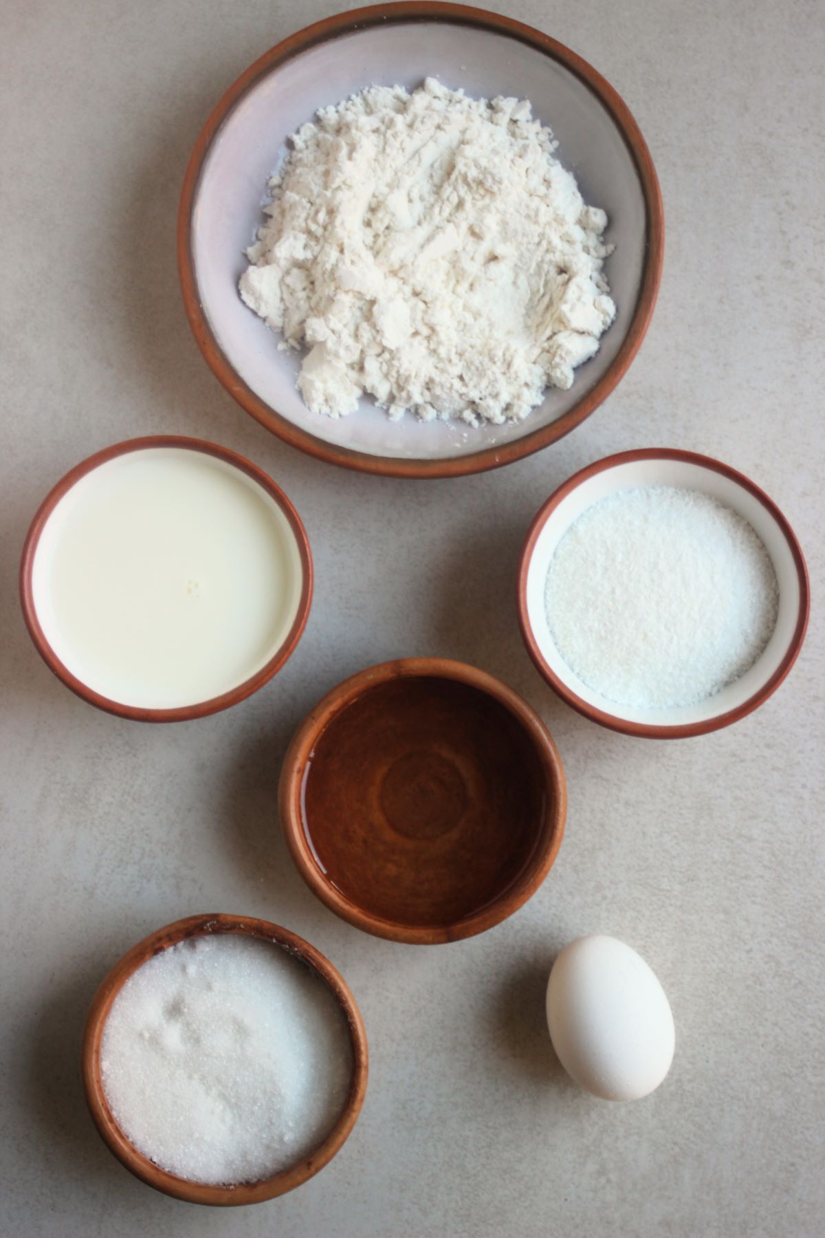 Coconut muffin ingredients on a white surface seen from above.