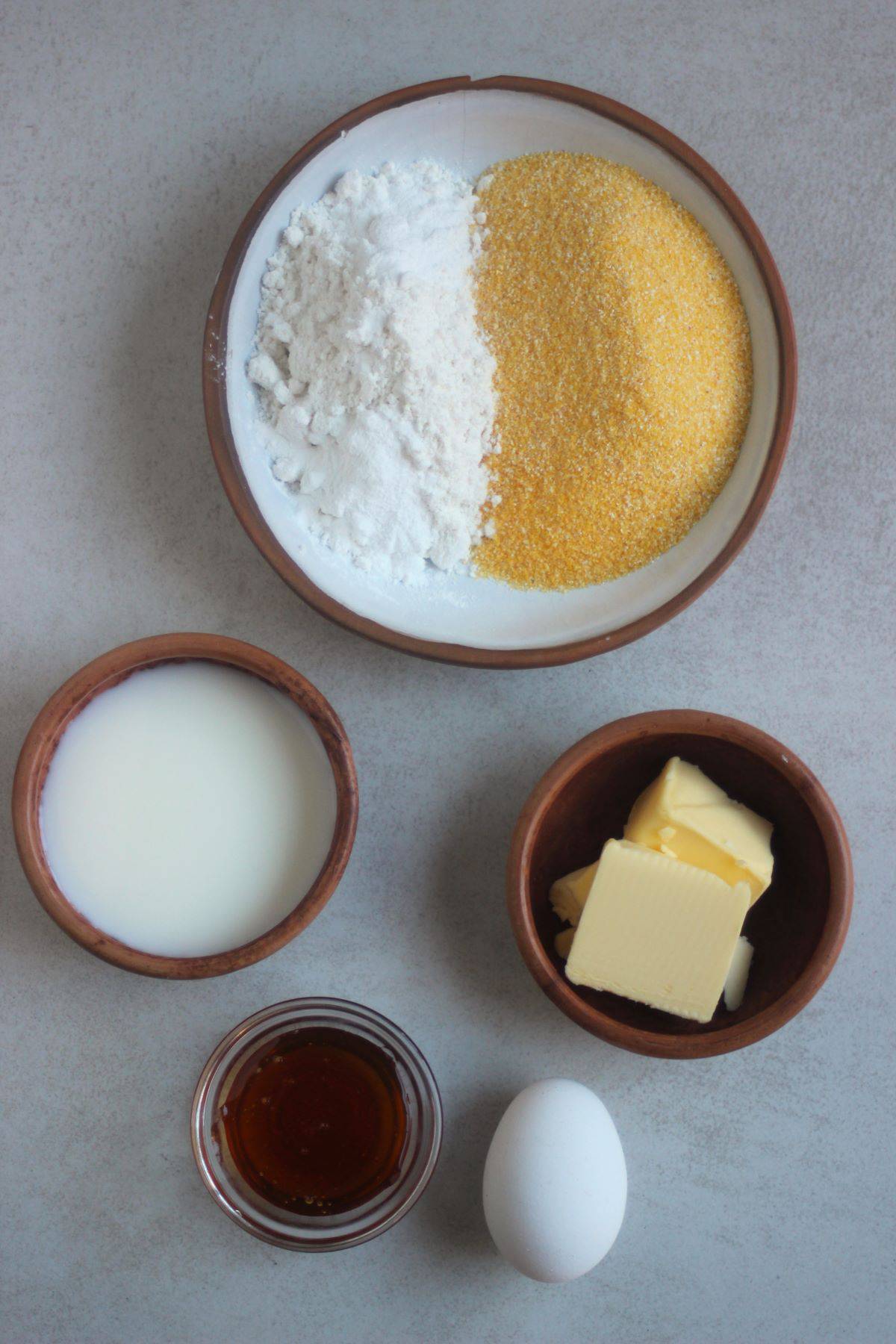 Cornbread muffins ingredients on a white surface seen from above.