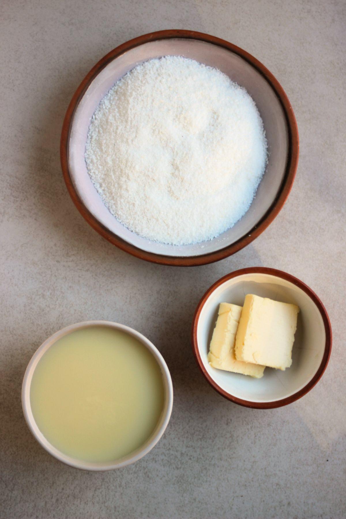 Coconut brigadeiros ingredients on a white surface seen from above.
