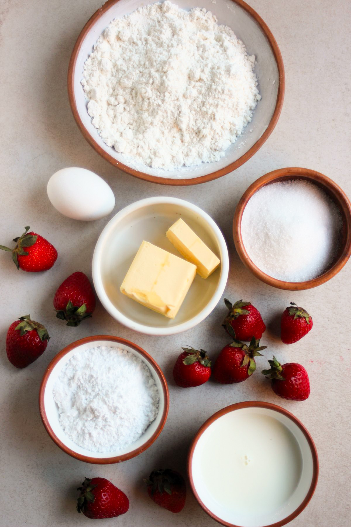 Strawberry whoopie pie ingredients on a white surface seen from above.