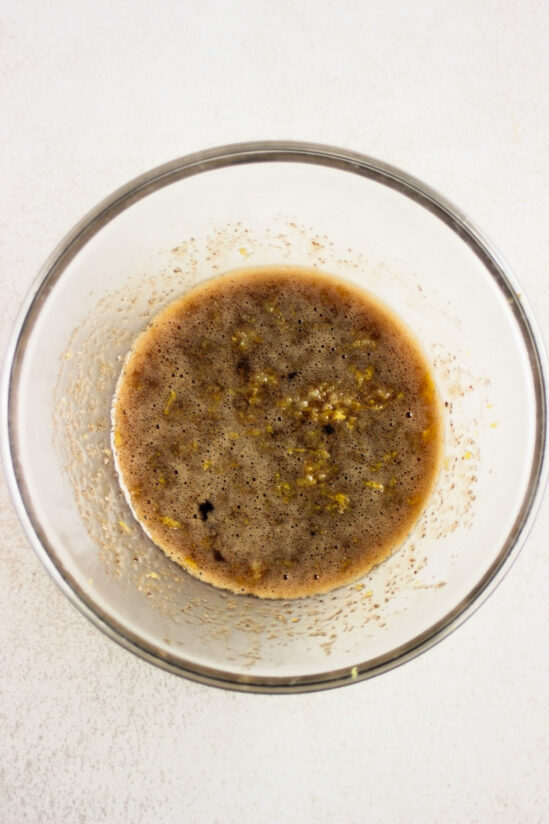 Glass bowl with a brown liquid.