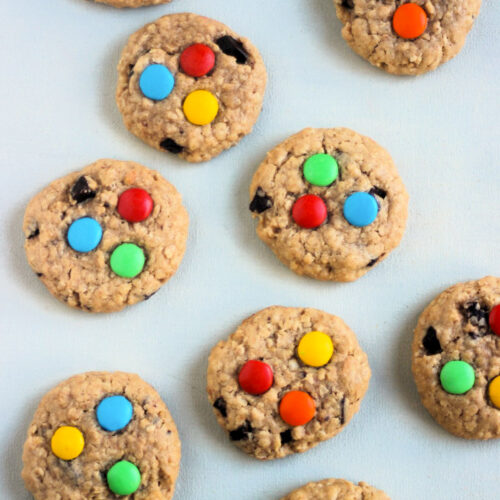 Top view of monster cookies on a white surface.