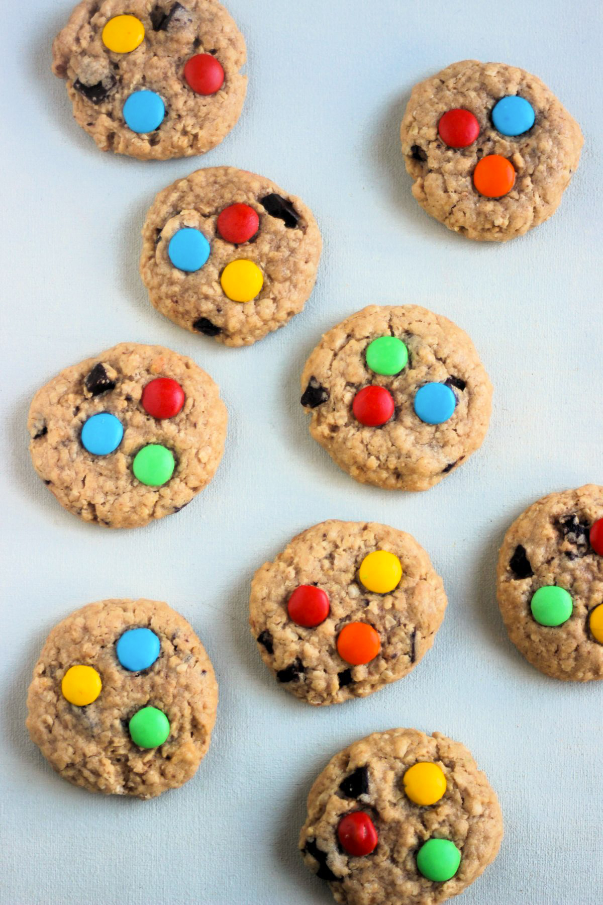 Top view of monster cookies on a white surface.