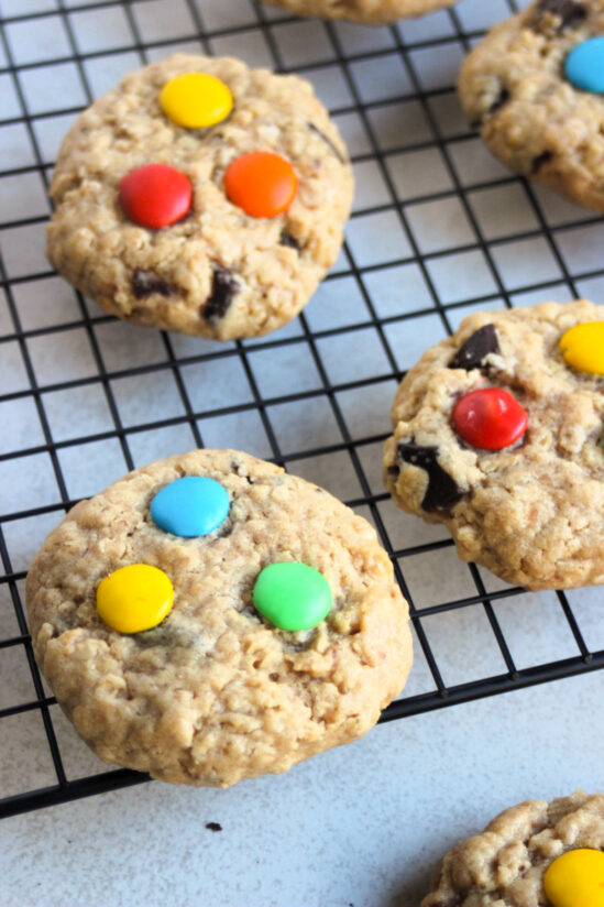 Monster cookies on a wire rack.