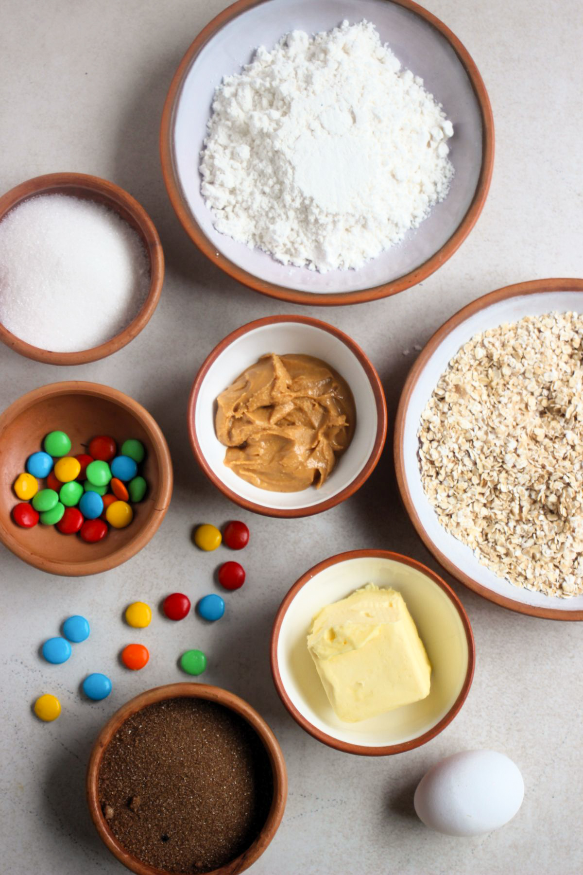 Monster cookies ingredients on a white surface seen from above.