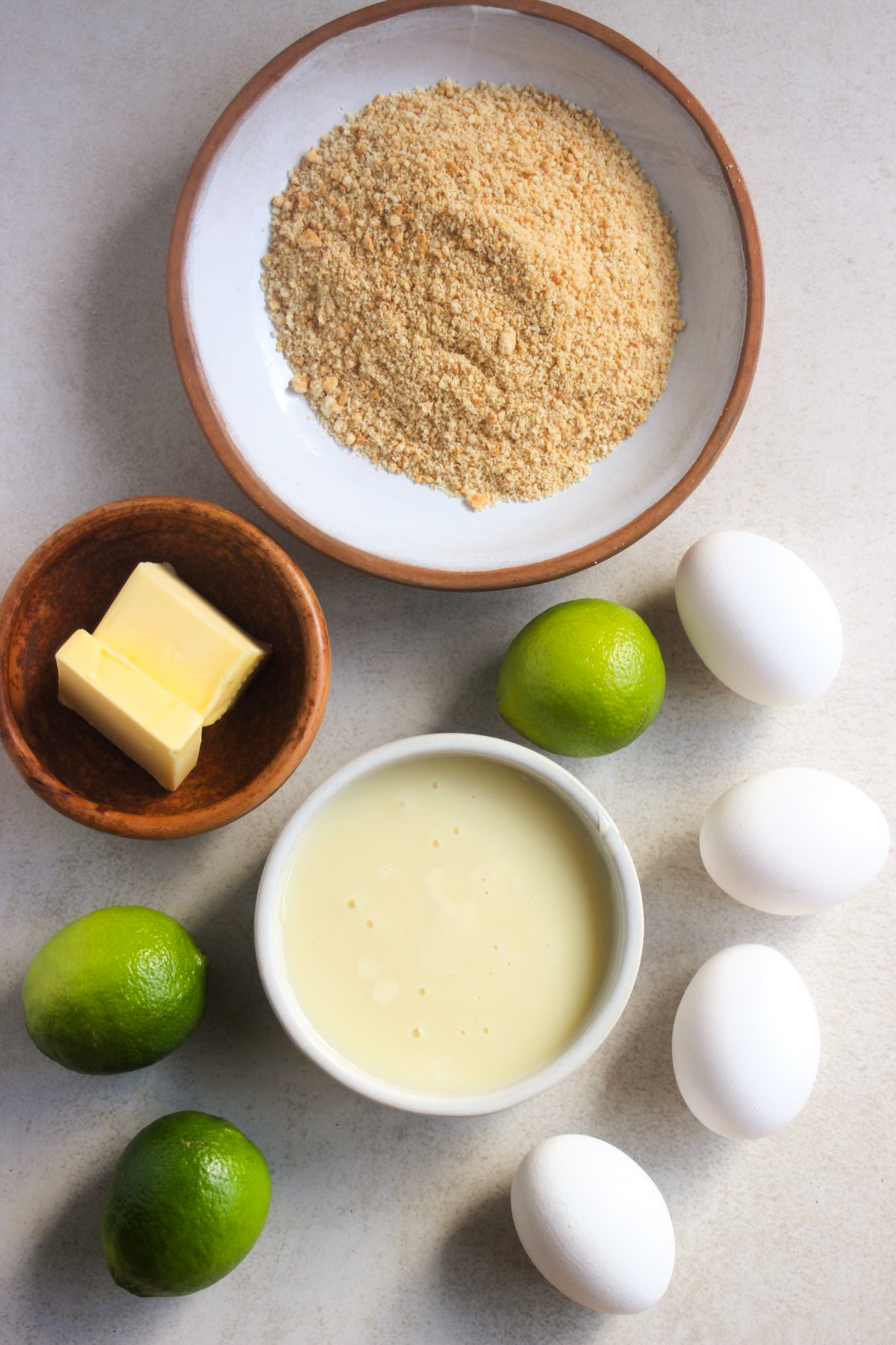 Top view of mini key lime pie ingredients on a white surface.