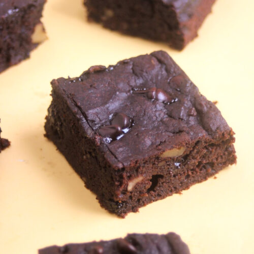 Sweet potato brownie on a yellow surface.
