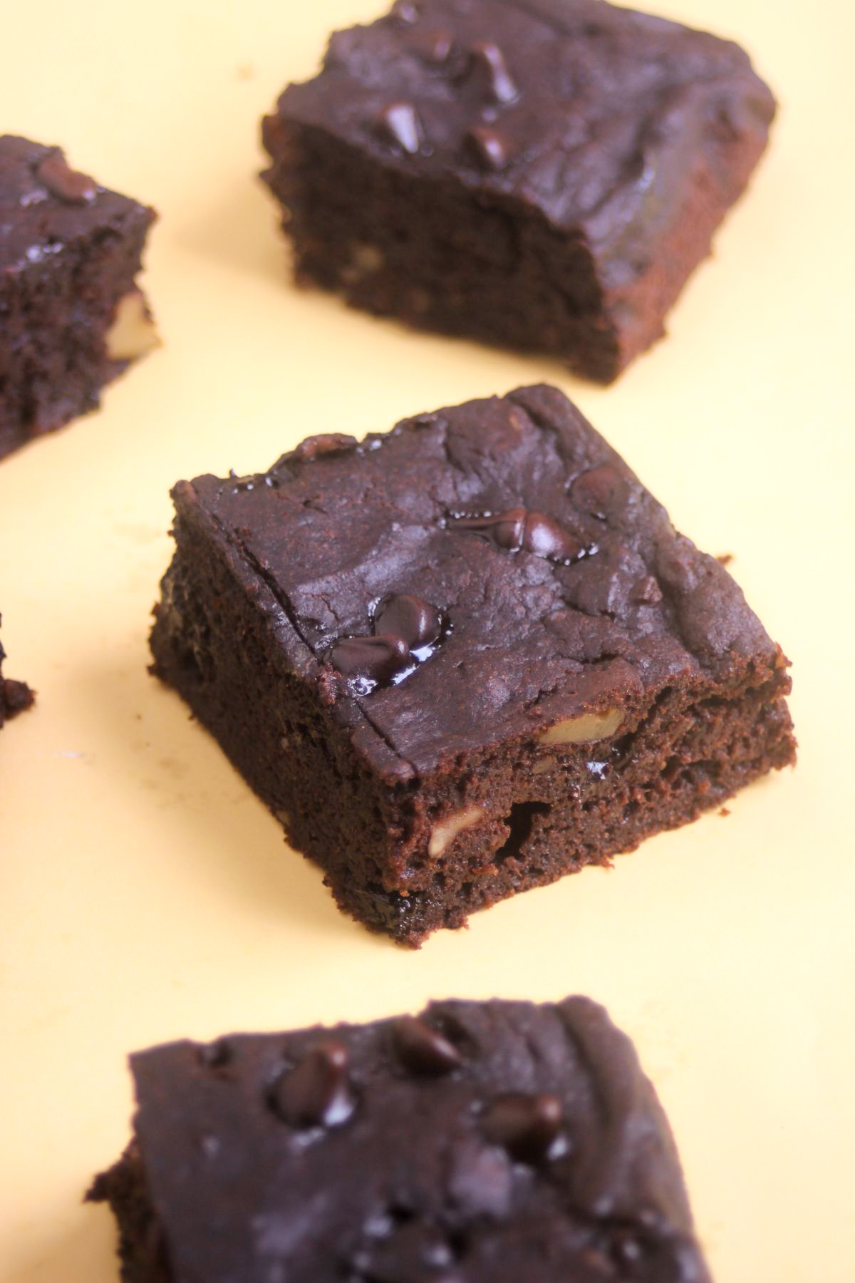 Sweet potato brownie on a yellow surface.