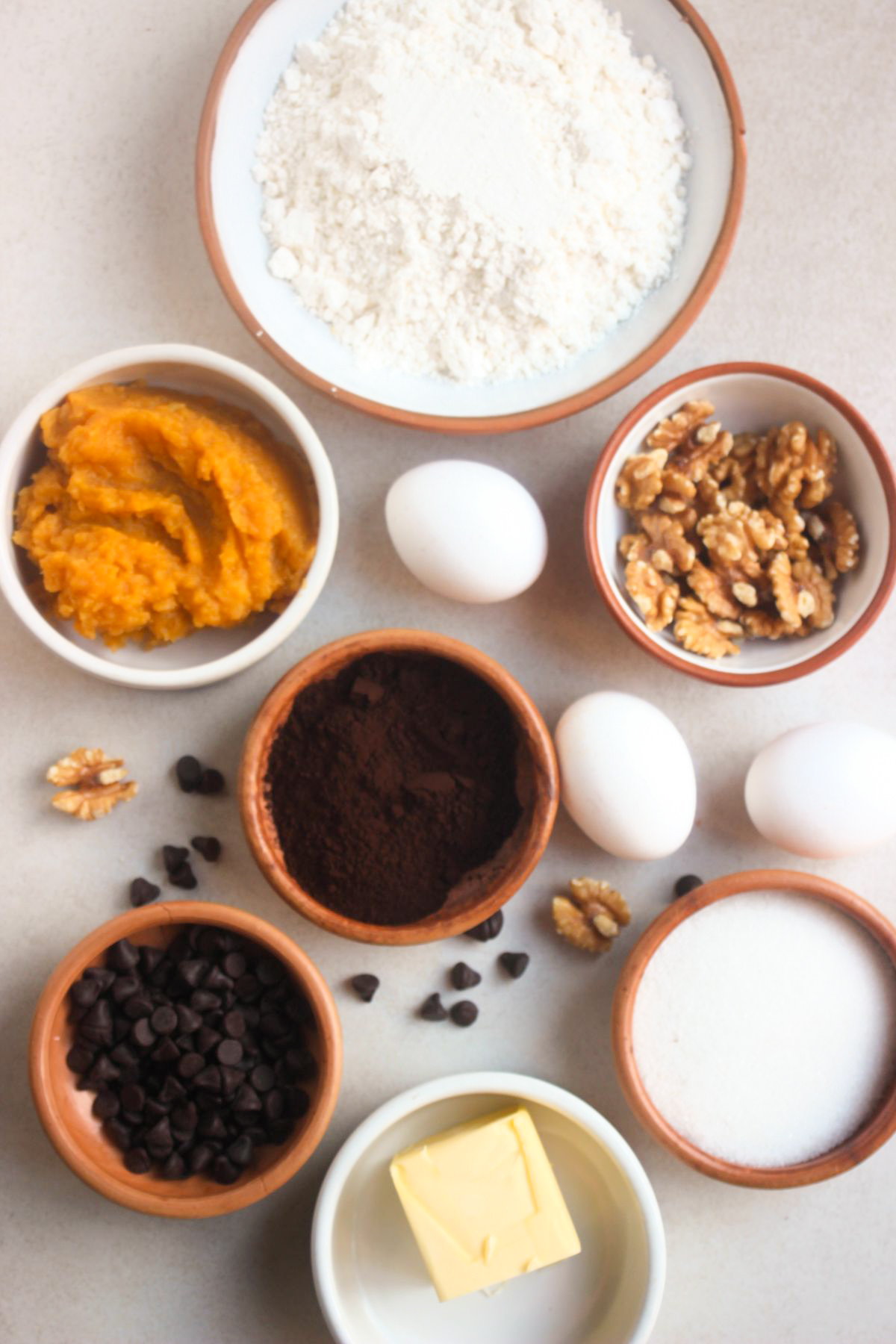 Top view of sweet potato brownies ingredients on a white surface.
