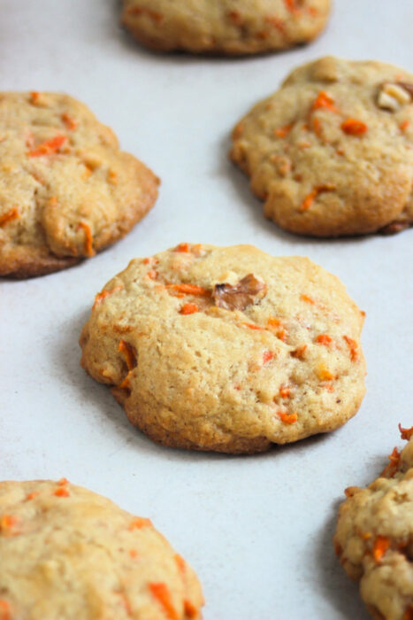 Carrot cake cookies on a white surface.