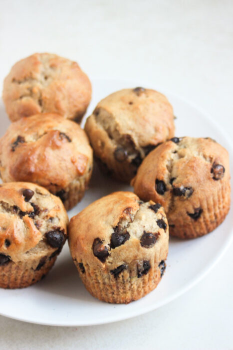 Banana chocolate chip muffins on a white plate.