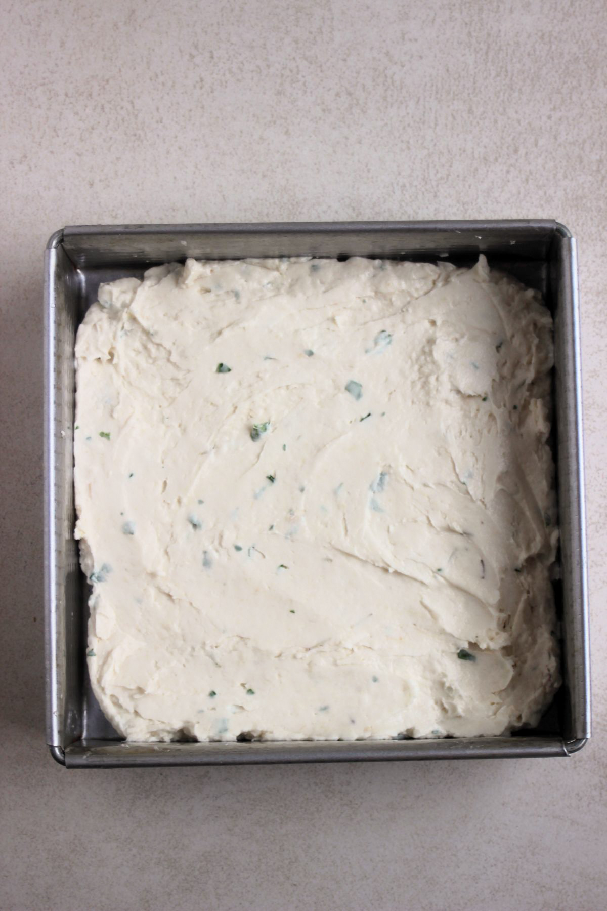 Square baking pan with focaccia dough.