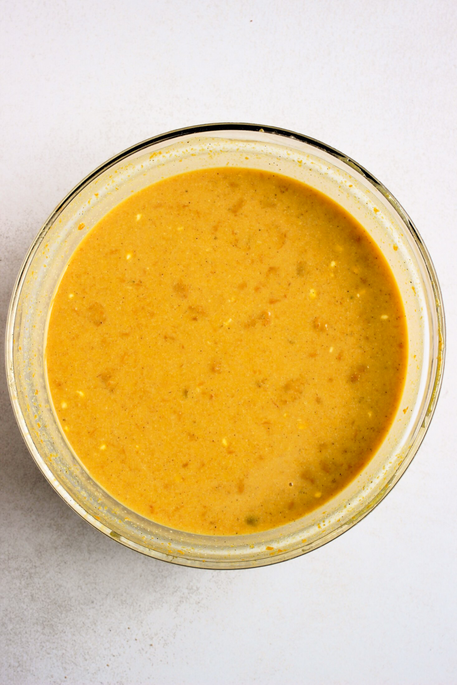 Glass bowl with pumpkin flan mixture.